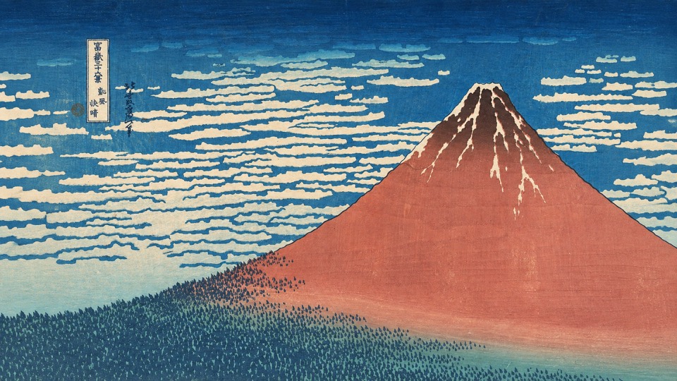 A bold red Mount Fuji beneath a deep blue sky and patterned white clouds.